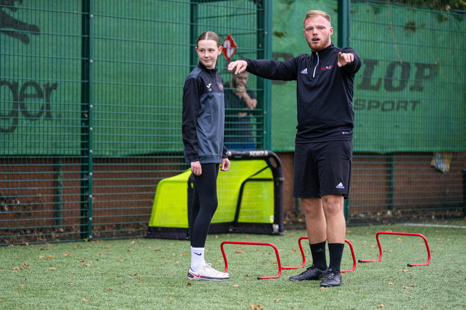 Coach Dan setting up an agility drill with a young player