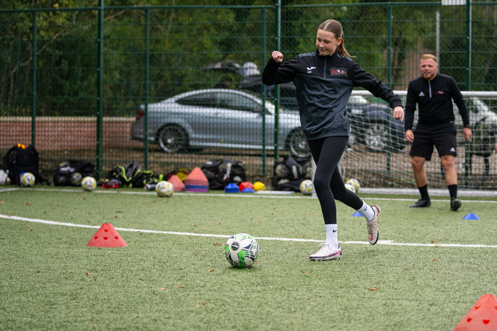 Girl driving forward with the ball at a Kick On Girls session