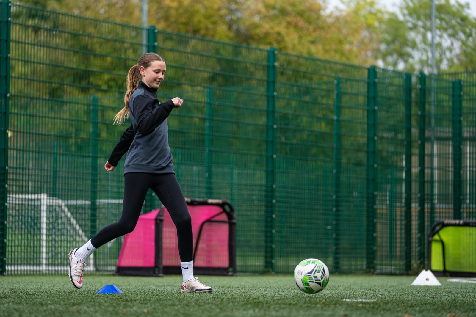 Young player dribbling through cones during a one-to-one session