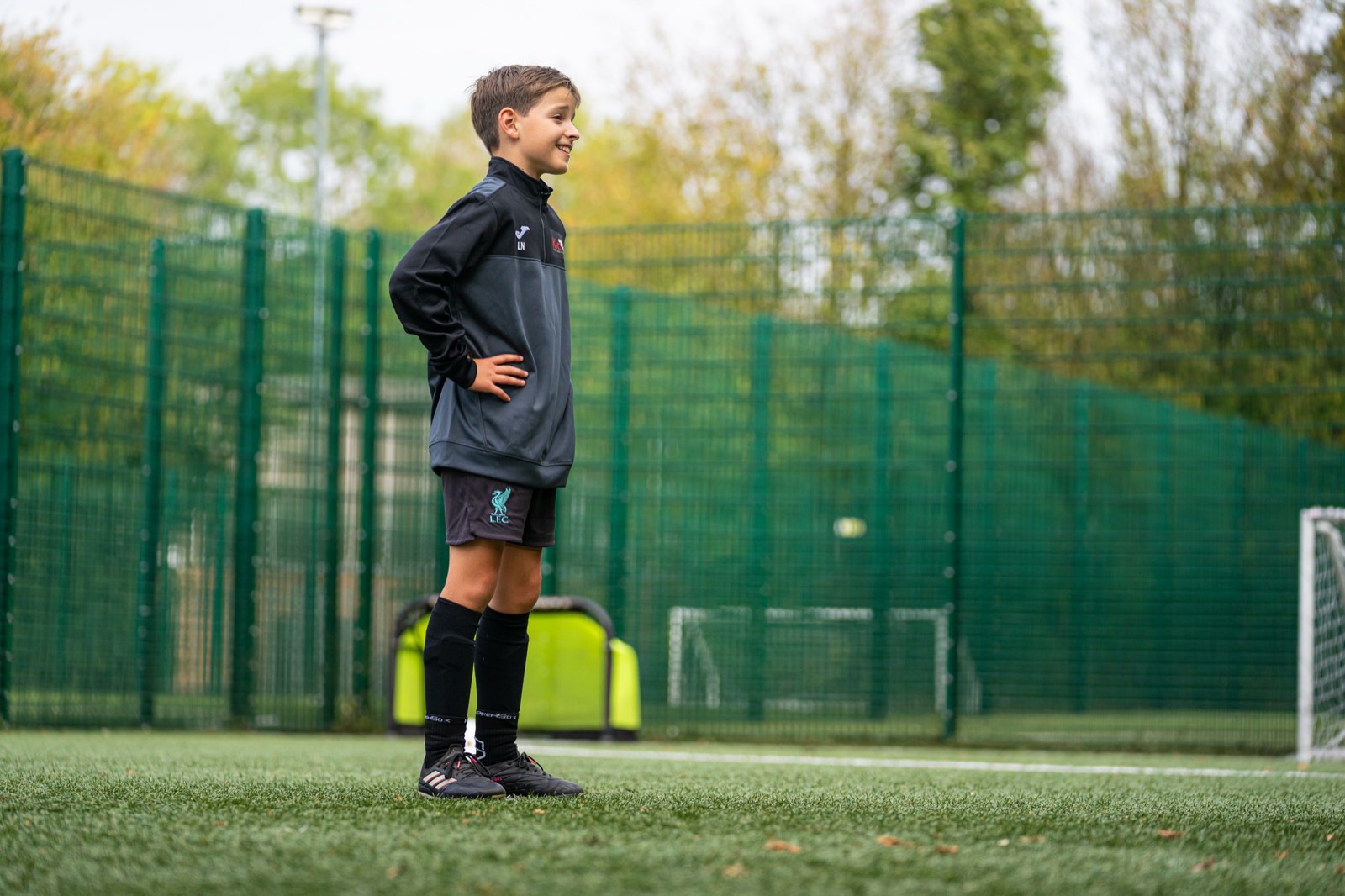 Young player smiling with hands on hips after a drill